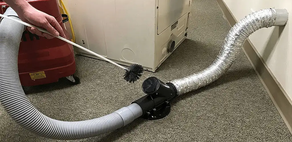 Dryer vent cleaning service removing lint from a dryer duct connection in Spokane, WA