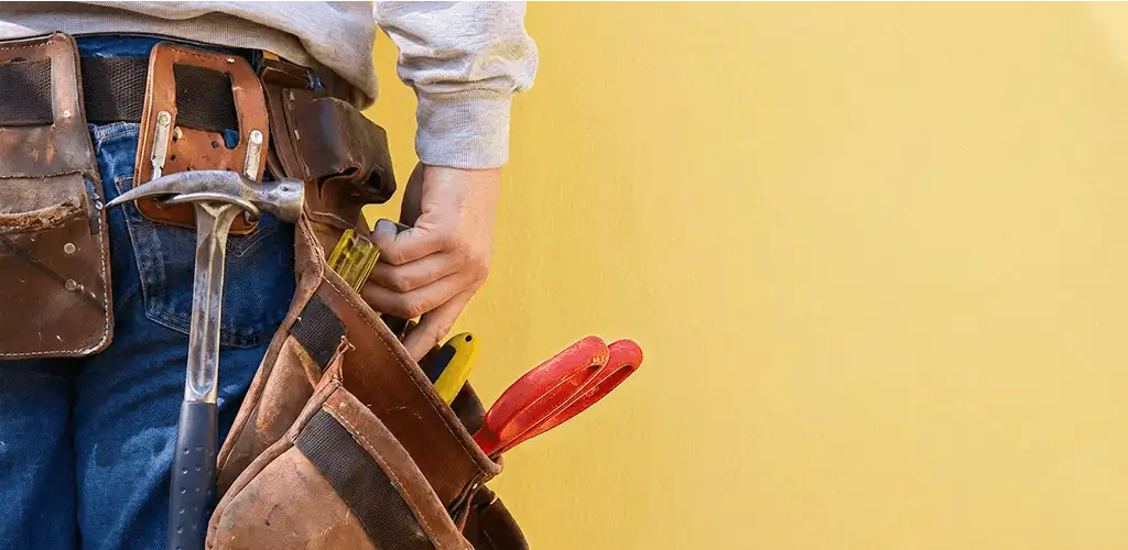 Handyman with tool belt ready for home repairs and maintenance in Spokane, WA