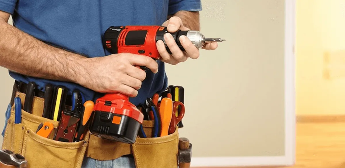 Handyman holding a power drill for home repairs and installations in Spokane, WA