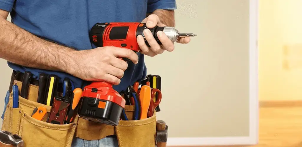 Handyman holding a power drill for home repairs and installations in Spokane, WA