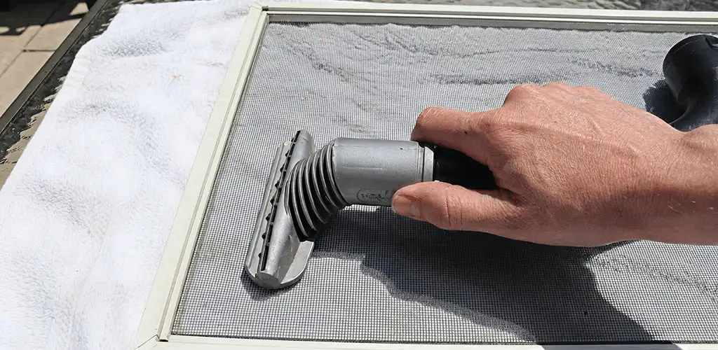 Window screen repair cleaning and fixing a damaged screen mesh in Spokane, WA